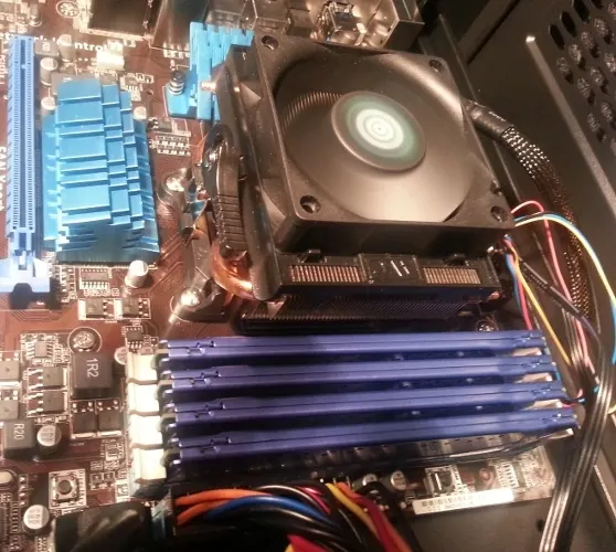 Desktop PC interior after an upgrade with a new CPU cooler and four RAM sticks installed